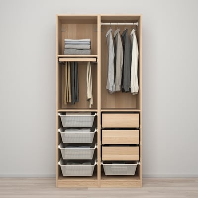Open wooden wardrobe showing organized clothes: hanging shirts, folded sweaters, and grey storage baskets.