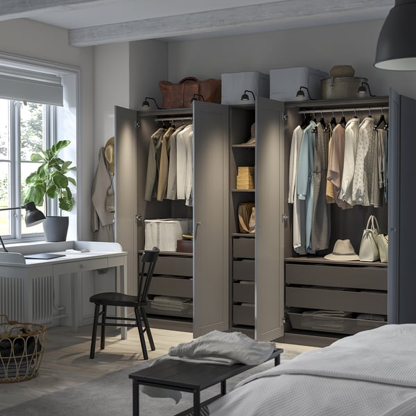 Modern bedroom with PAX wardrobe, hangers, shelves, drawers, and integrated lights.