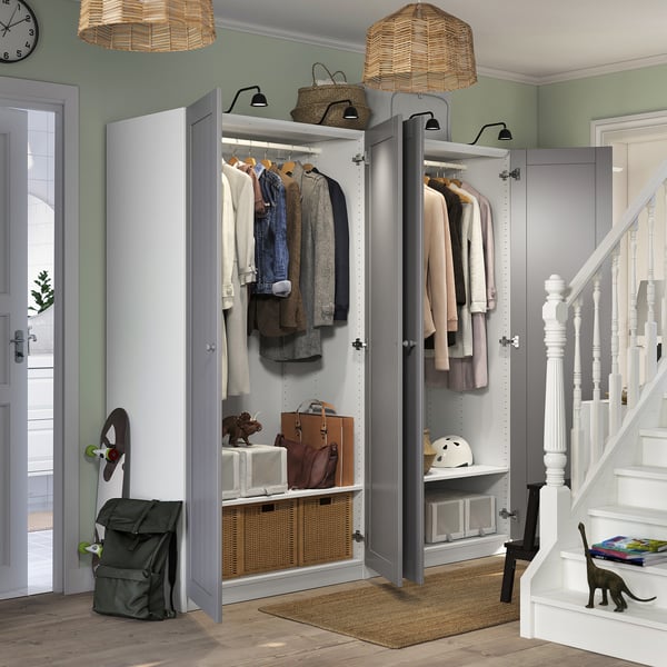 Modern entryway with open wardrobe, pendant lights, and cat.