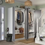 Modern entryway with open wardrobe, pendant lights, and cat.