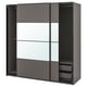 A dark gray PAX wardrobe with sliding doors. It has a sleek, modern design with mirrored panels and mesh storage baskets.