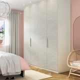 Modern bedroom with textured PAX wardrobe in neutral tones, wave pattern, next to window.