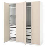 This image displays an open beige PAX wardrobe with drawers and shelves for clothes storage. The design adjustable feet and soft-closing hinges.