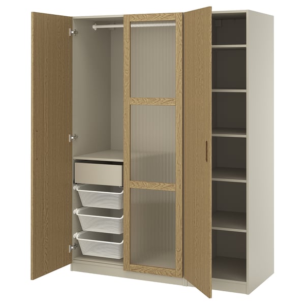 PAX wardrobe - wooden doors open to reveal shelves and mesh drawers, light oak finish.