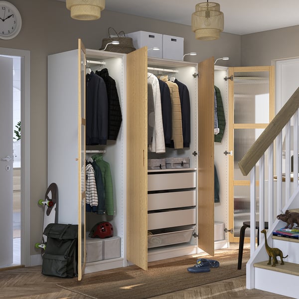 Well-organized closet displaying clothes hangers, drawers, and storage boxes. Built-in lighting emphasizes neatly arranged items.