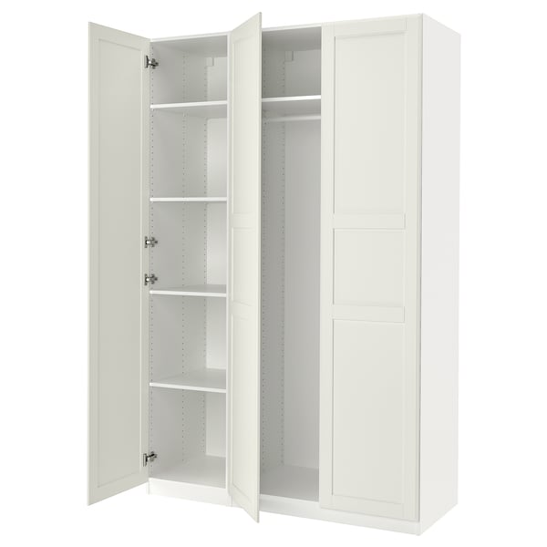 An open off-white IKEA PAX wardrobe with adjustable shelves and hanging space.