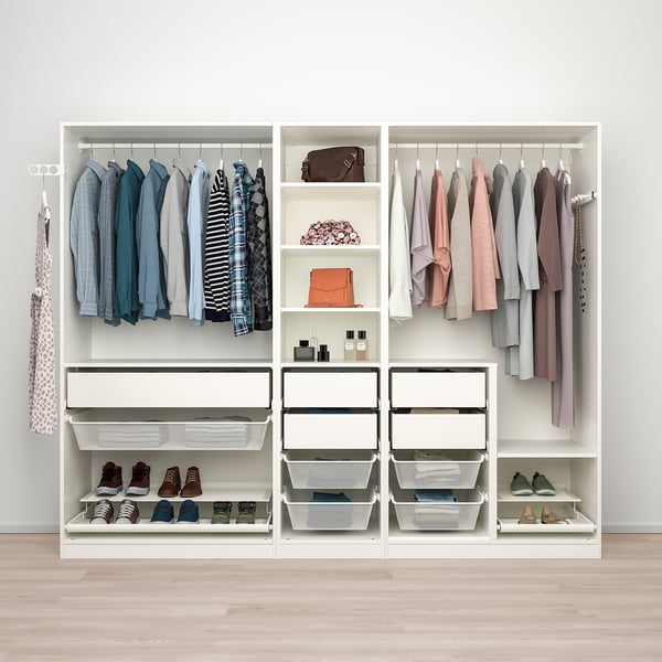 A white PAX wardrobe organises clothes, shoes, and accessories with shelves, drawers, and hanging space.