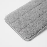 Close-up of a soft, light gray microfiber cloth on a white background, showcasing its texture and high quality.