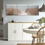 Triptych beach scene art above sideboard, adds depth to minimalist decor.
