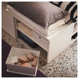 Minimalist bedroom with PLATSA bed, striped pillow, and terrazzo floor
