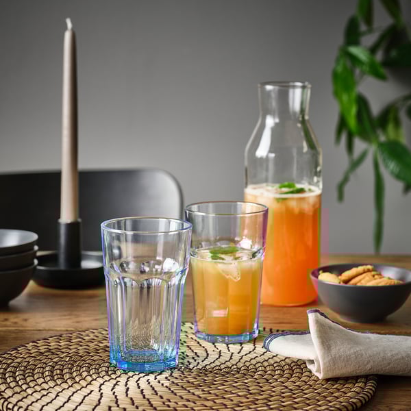 Table setting with glasses, orange juice, and cookies. Durable tempered glass.