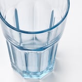 Clear glass cup with blue rim, robust design, seen from above.