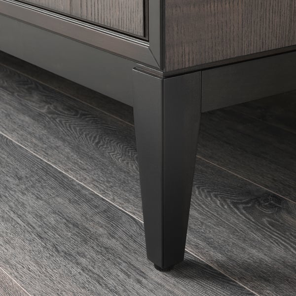 Dark wood cabinet with sleek, angled legs; well-crafted, sturdy design.