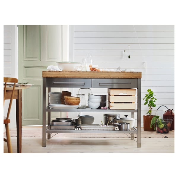 Modern kitchen island, RIMFORSA. Bamboo top, metal base. Storage drawers, shelves for bowls, pans, and crates. Light wood, sleek design.