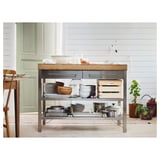 Modern kitchen island, RIMFORSA. Bamboo top, metal base. Storage drawers, shelves for bowls, pans, and crates. Light wood, sleek design.