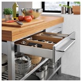 Kitchen island with bamboo top, stainless steel base, and wooden drawer organizer.