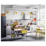 Modern kitchen with yellow accents, RIMFORSA bamboo island, stainless steel appliances, white tiled backsplash, and hanging lamps.