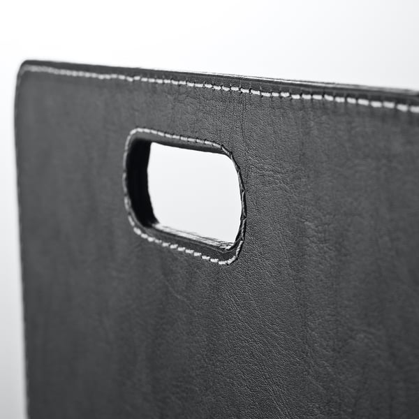 Black desk organizer with sturdy handle and refined stitching, perfect for tidying essentials.