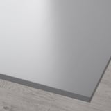 Close-up of a smooth, grey tabletop with a sleek, glossy finish and a peripherally visible wooden floor.