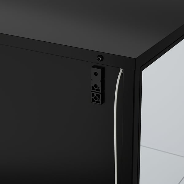 Black cabinet with integrated lighting. Cable management visible on side.