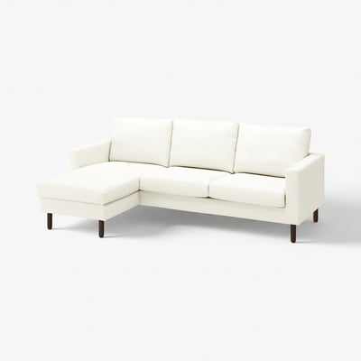 White l-shaped sofa with wooden legs, upholstered in cotton, clean-lined and modern.
