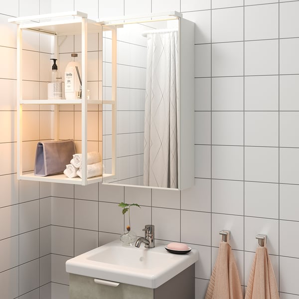 Mirrored bathroom cabinet with led lighting and sink.