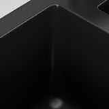 Black kitchen sink with sleek, seamless design and sloping drainboard. High-quality material, tough and stain-resistant.