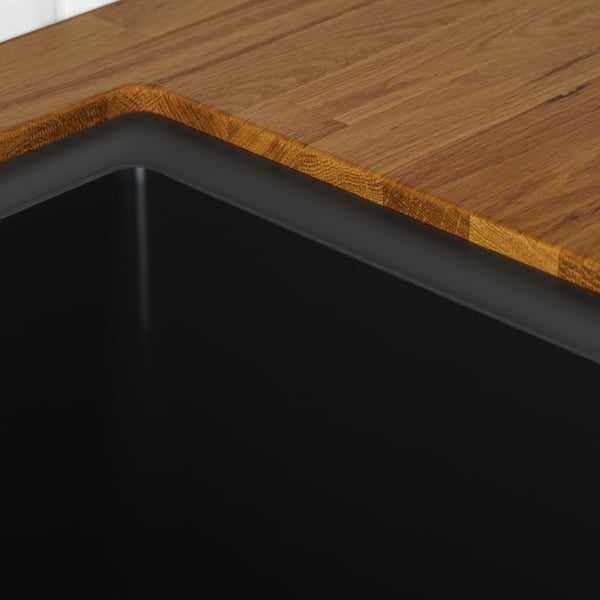 Wooden table edge, smooth, durable surface. Black metal frame support.