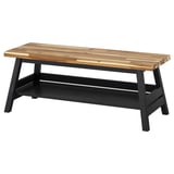 The SKOGSTA bench with a natural wood top and black legs, featuring a shelf for storage.