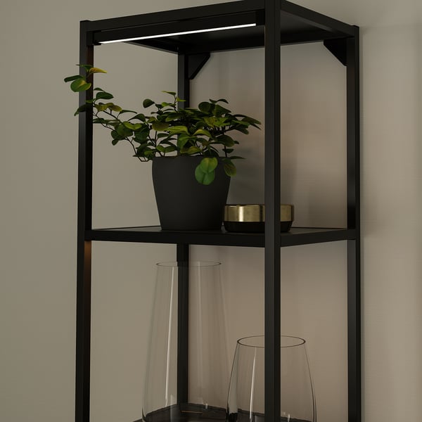 Black shelf with led light, holds plants & vases.