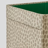 Fabric-covered storage box, beige with brown dots, sturdy, handles for portability.