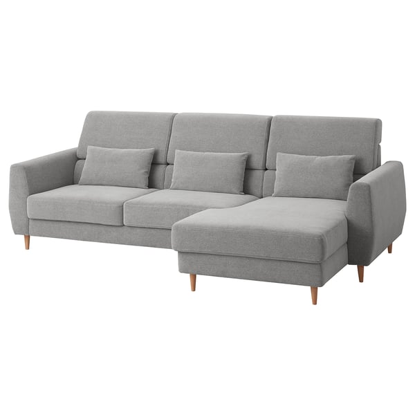Modern light gray l-shaped sofa with wooden legs, high back, and loose cushions. Comfortable and stylish for relaxation.