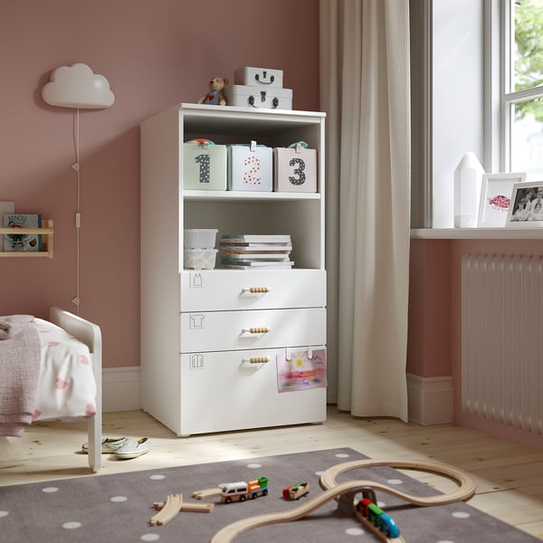 White SMÅSTAD bookcase in childs room with toys and train set.