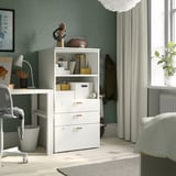 A white SMÅSTAD storage unit with shelves and drawers in a styled room.