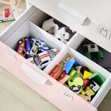 Organized toy storage: white SMÅSTAD drawers filled with colorful toys.