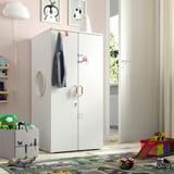 Kids room with SMÅSTAD wardrobe, colorful rug, open balcony door, pink walls.