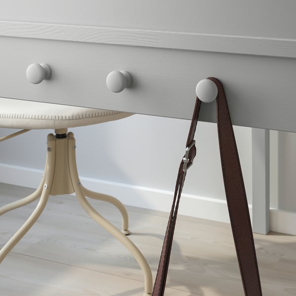 Desk with drawer and side knobs for hanging items; part of SMYGA series.