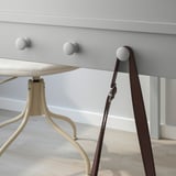 Desk with drawer and side knobs for hanging items; part of SMYGA series.