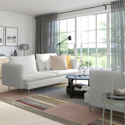 Modern living room with SÖDERHAMN sofa, colorful decor, plant, and window view.