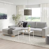 Grey sectional sofa, modern, with large cushions.