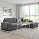 Modern grey l-shaped sofa set with wooden coffee table in a bright living room.