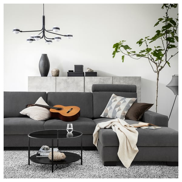 Modern living room with a gray SÖRVALLEN sofa, featuring a coffee table, decor, and pendant lights.