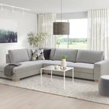 Modern living room with large gray SÖRVALLEN sectional sofa, white coffee table, and large windows.