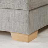 Close-up of a modern sofas wooden leg, showcasing its sturdy design and clean finish.
