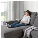 Woman on eco-friendly SÖRVALLEN sofa reading.