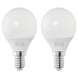 Two ikea led light bulbs, round and white, made of plastic.