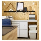 Office desk setup with white SORTERA storage bins, a blue printer, and a wall with shelves and tools.