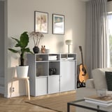 Gray SPIKSMED storage unit with decor, open/closed cabinets, wood floor, gray rug, modern style.