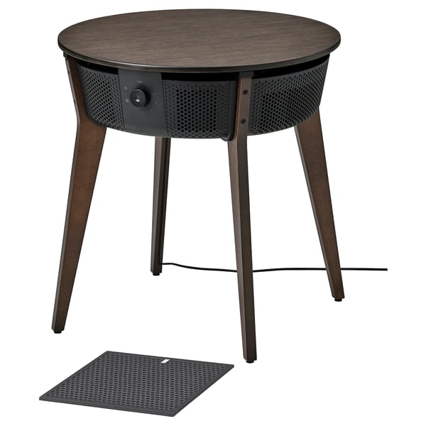 An ikea STARKVIND, a modern black side table air purifier with wooden legs, featuring a perforated design and digital controls.