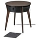 An ikea STARKVIND, a modern black side table air purifier with wooden legs, featuring a perforated design and digital controls.